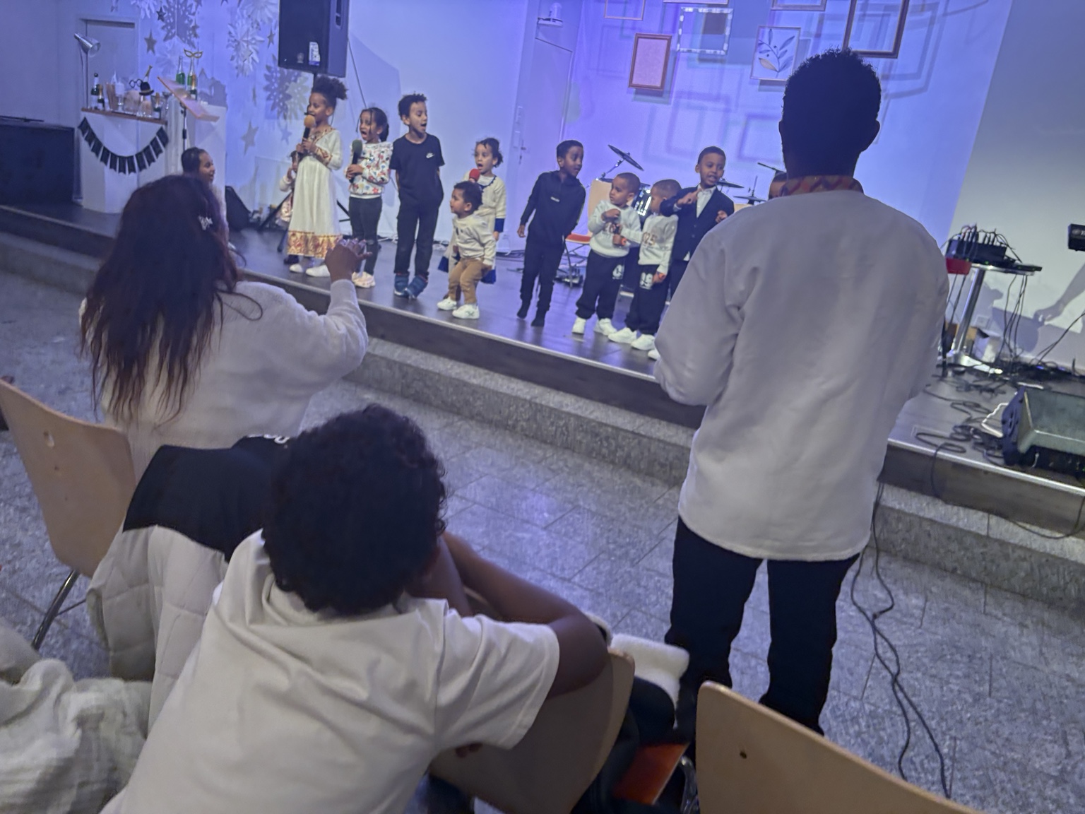 Children worshipping together at Church of the Living God Bern